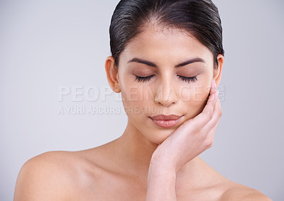 Buy stock photo Woman, relax and face with skincare, cosmetics or facial treatment on a gray studio background. Young female person, brunette or model with smile in satisfaction for beauty, makeup or spa on mockup