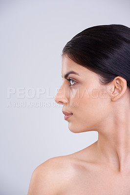 Buy stock photo Woman, face and profile with skincare, cosmetics or facial treatment on a gray studio background. Young female person, brunette or model with smile in satisfaction for beauty, makeup or spa on mockup