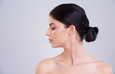 Buy stock photo Studio shot of a beautiful young woman with her eyes closed against a gray background