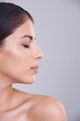 Buy stock photo Woman, relax and profile with face in skincare, cosmetics or facial treatment on a gray studio background. Young female person, brunette or calm model in satisfaction for beauty or makeup on mockup