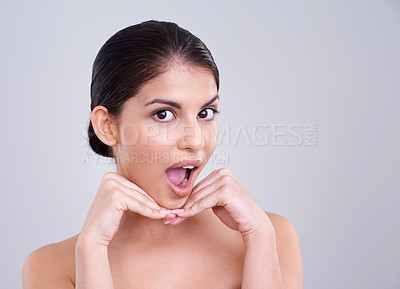 Buy stock photo Woman, portrait and surprise with skincare, cosmetics or makeup n a gray studio background. Face of young female person, brunette or model in shock for facial treatment, spa or beauty on mockup space
