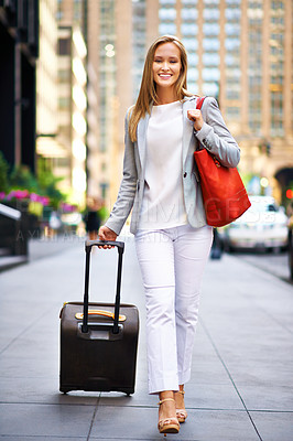 Buy stock photo Business woman, luggage and portrait on urban sidewalk with smile, journey and outdoor with pride. Person, happy and baggage on travel in city on metro street by skyscraper buildings in New York