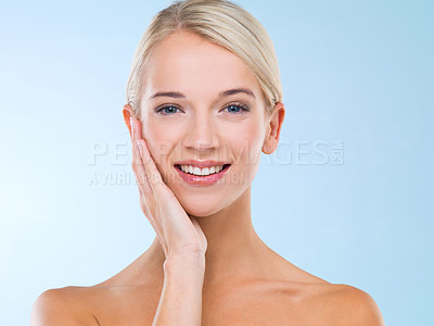 Buy stock photo Woman, portrait and skincare beauty with hand for healthy treatment, blue background or confidence. Female person, face and smile or makeup cosmetics as dermatology wellness, studio or mockup space