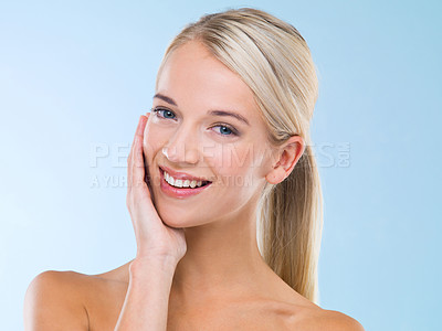 Buy stock photo Beauty, portrait and woman with skincare cosmetics in studio with health, wellness and face routine. Smile, natural and female person with dermatology facial treatment isolated by blue background.