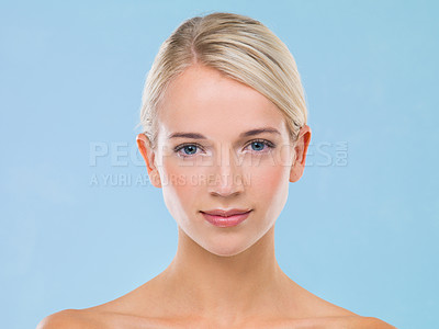 Buy stock photo Studio portrait of a beautiful blonde woman against a blue background