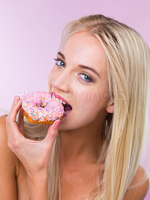 Buy stock photo Cropped shot of a woman eating a donut while isolated on pink