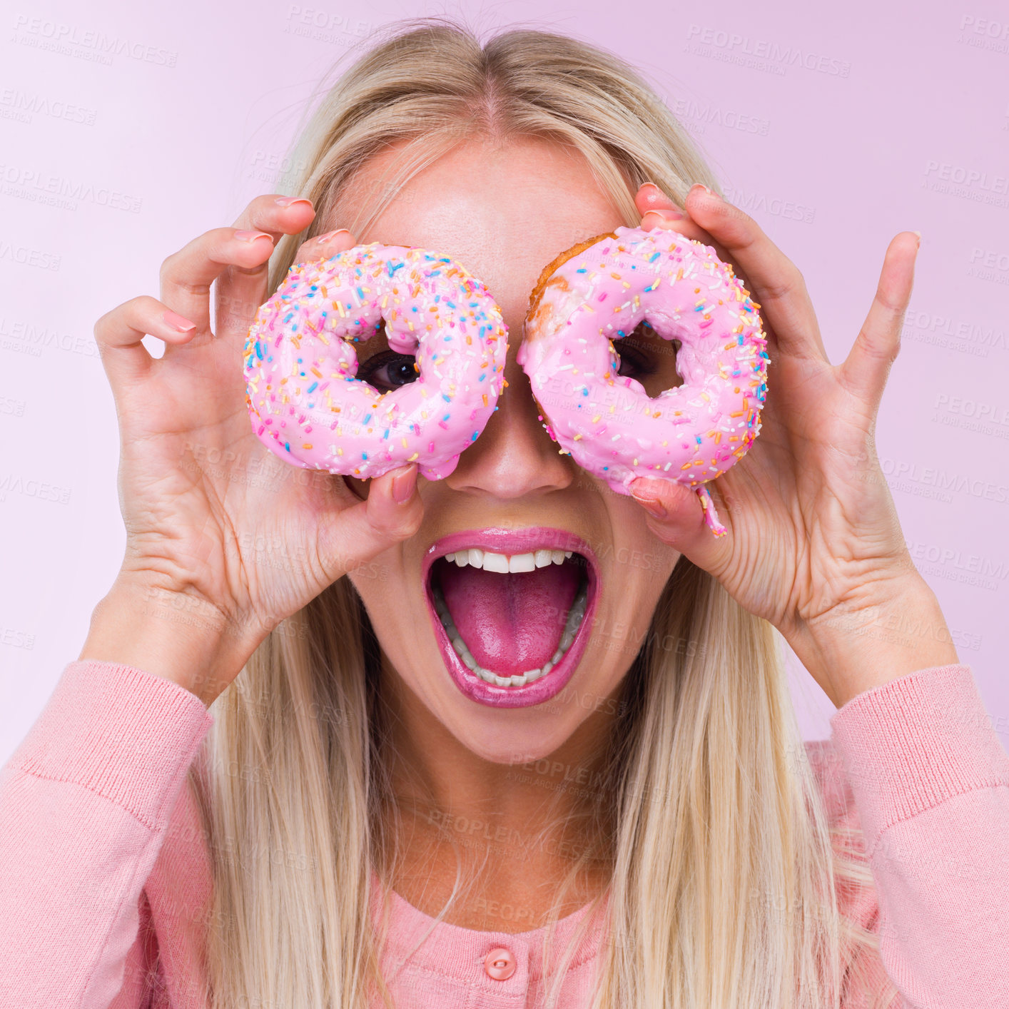 Buy stock photo Cropped shot of a woman holding donuts in front of her eyes while isolated on pink