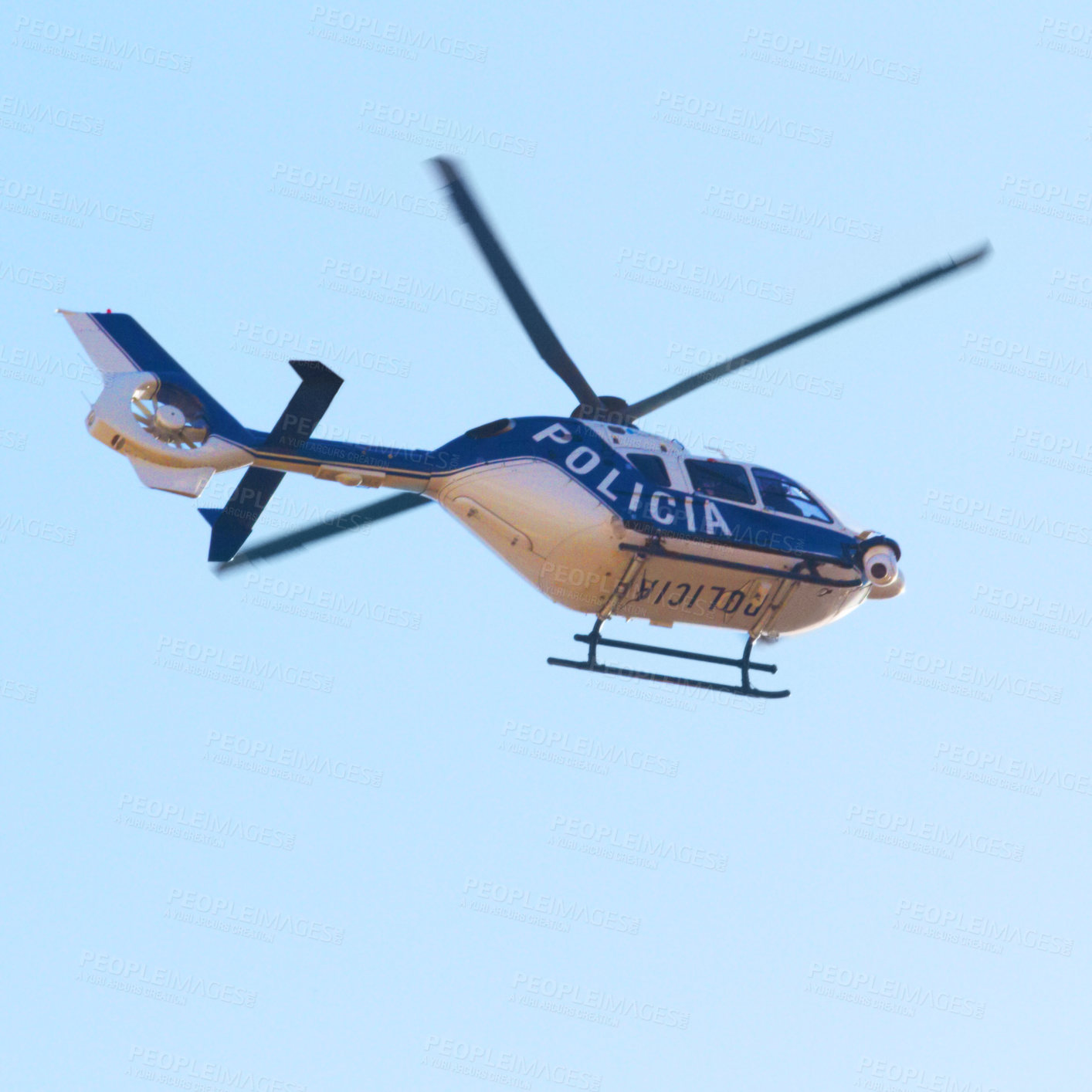 Buy stock photo Low angle shot of a police helicopter in the sky