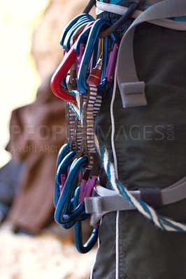 Buy stock photo Carabiners, rock climbing gear and harness for safety in adventure sport equipment and exercise in mountain. Fitness, activity or steel rope for grip or anchor point connection for secure attachment