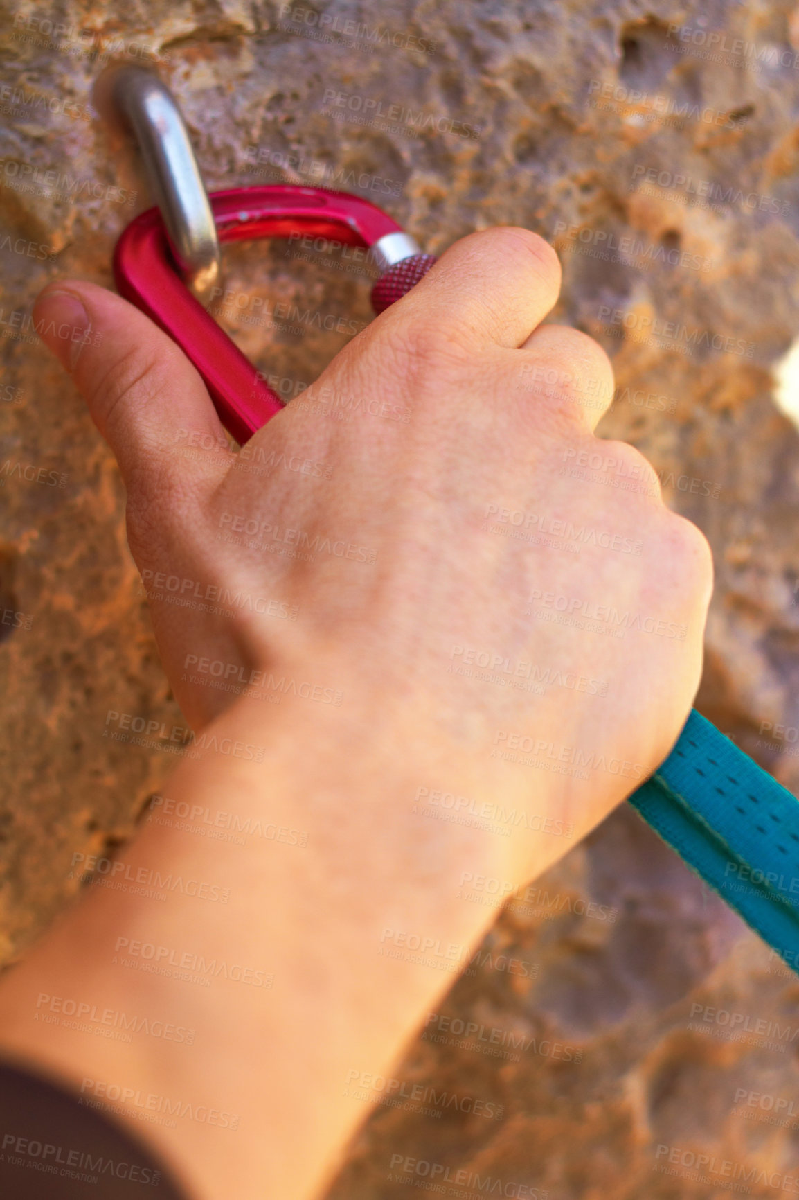Buy stock photo Closeup of a climber's hands clipping a quickdraw onto a hook bolted into a rock