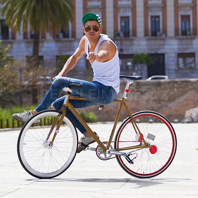 Buy stock photo Full length shot of a young guy cycling outdoors