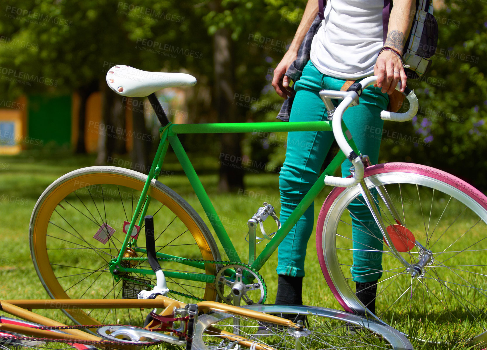 Buy stock photo Cropped shot of a young guy standing next to his bike outdoors