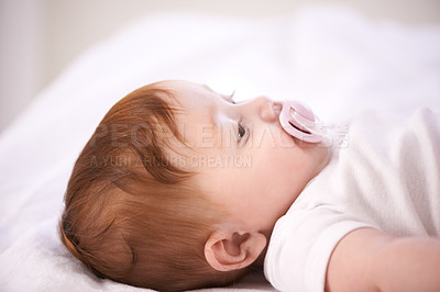Buy stock photo Baby, pacifier and relax on bed in home for with wellness, quiet and rest in morning in nursery. Infant, newborn and peace with soother, growth and closeup for childhood development in family house