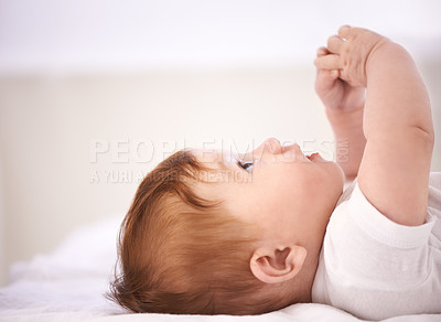 Buy stock photo Girl, baby and laying on bed with thinking for childhood development, growth and relax in bedroom. Newborn, infant and kid with curiosity for knowledge, peace or waking up in nursery at home