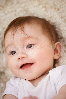 Buy stock photo Happy, sweet and closeup of baby on blanket playing for child development and curious face. Smile, cute and young girl kid, infant or newborn relaxing and laying on bed in nursery room at home.
