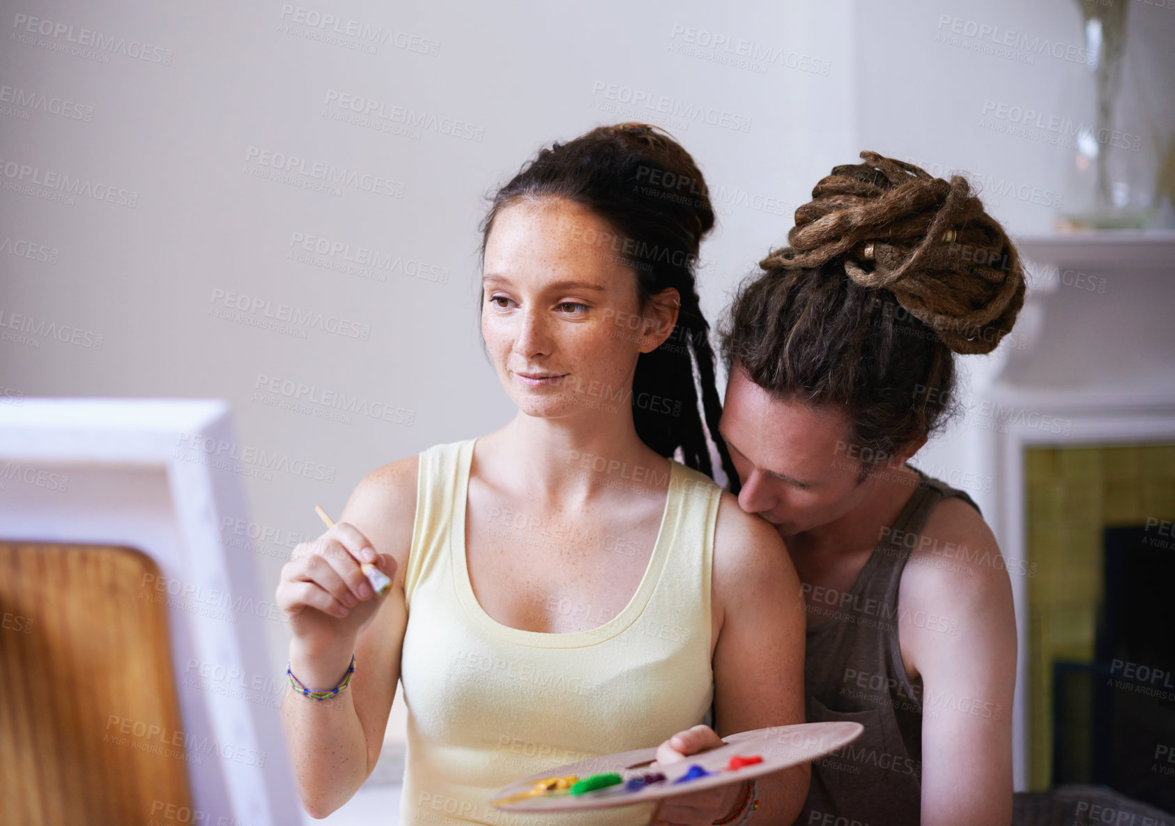 Buy stock photo A cropped view of a young artist painting with her boyfriend's support