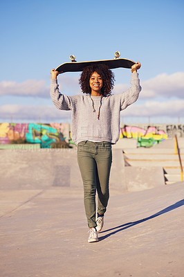 Buy stock photo Shot of a young woman out skateboarding in the city