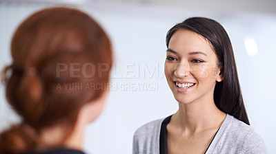 Buy stock photo A cropped shot of two young professionals talking in the office
