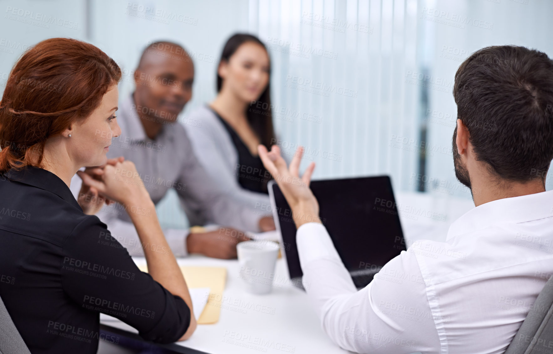 Buy stock photo A group of coworkers having a meeting