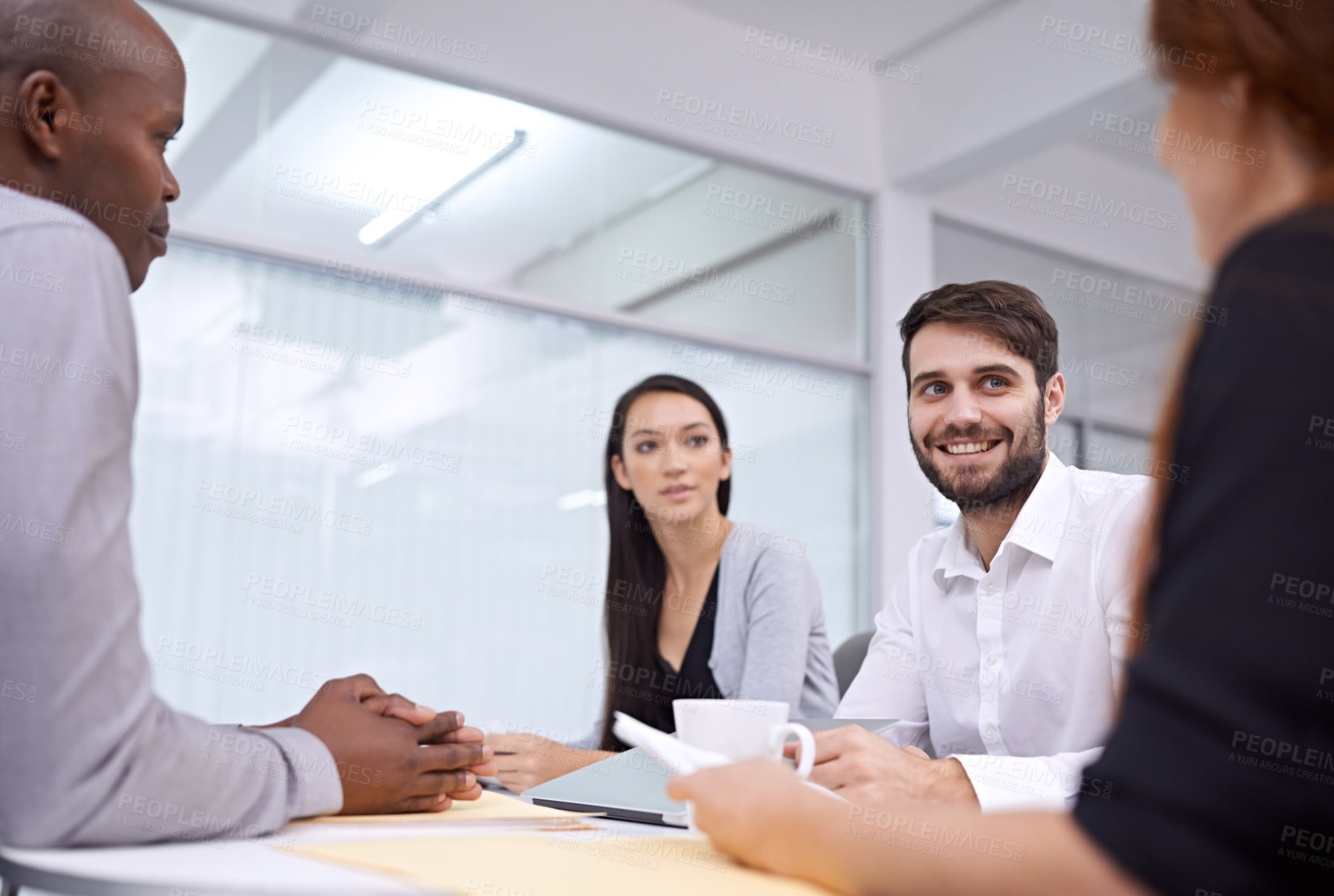 Buy stock photo A group of coworkers sitting in an office and having a meeting