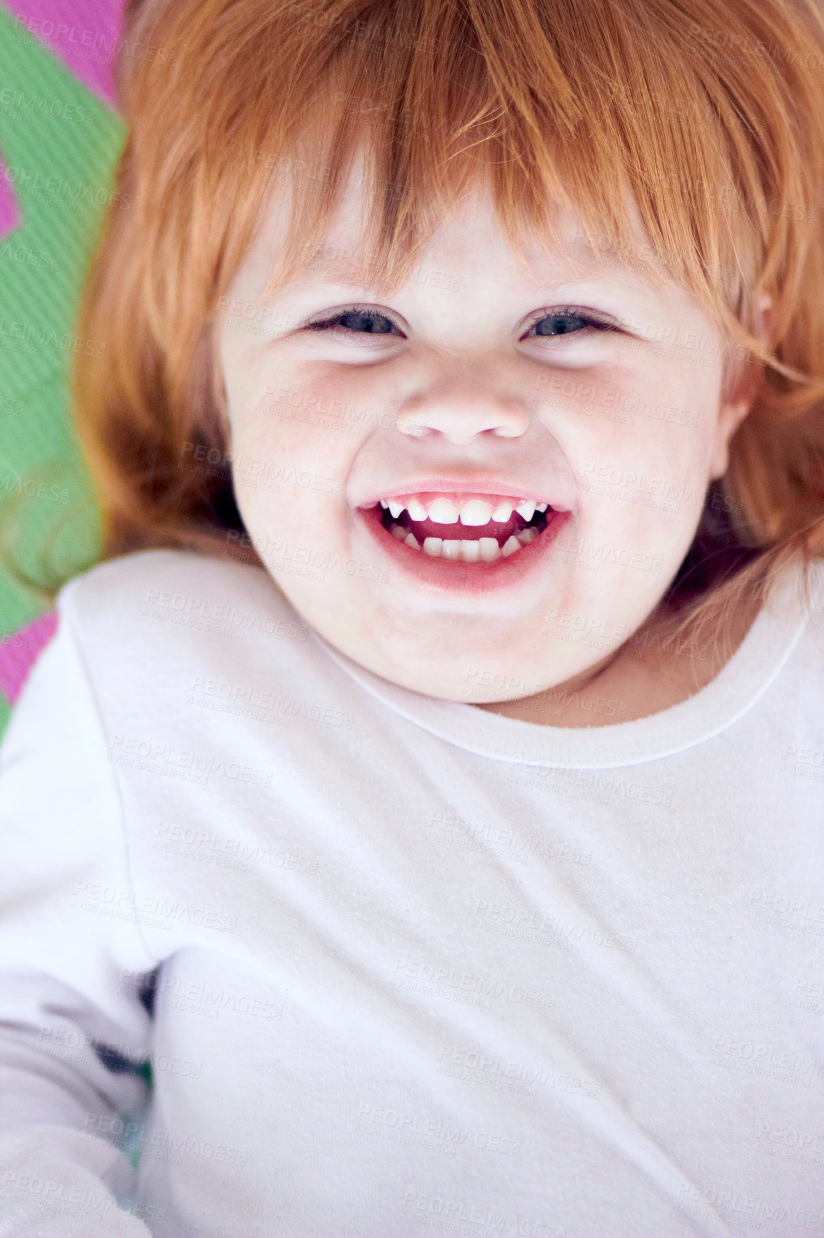Buy stock photo Young girl, laughing and funny portrait of a baby on a home playpen ground with a smile. Ginger infant, kid laugh and happy in a house with joy, youth and positivity from childhood looking up 