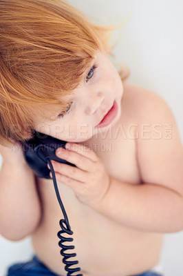 Buy stock photo Phone call, playing and cute young kid at home with ginger hair and youth. Conversation, telephone and learning child with communication and listening in a house with confidence and childhood