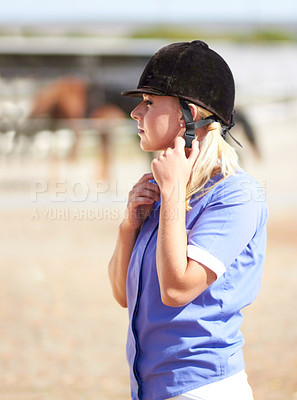 Buy stock photo Woman prepare, horse jockey and helmet of young athlete on equestrian training ground for show and race. Outdoor, female person and equipment fixing on animal farm for dressage with rider and horses