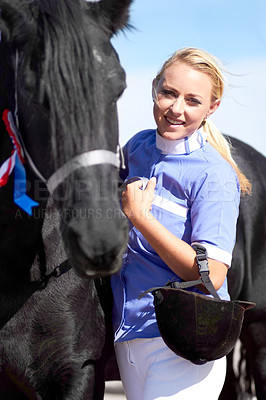 Buy stock photo Shot of a beautiful young woman standing next to her horse