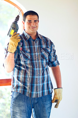 Buy stock photo Shot of an attractive male handyman with drill