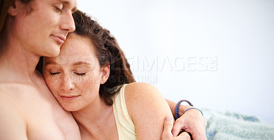 Buy stock photo A young couple sleeping in each other's arms