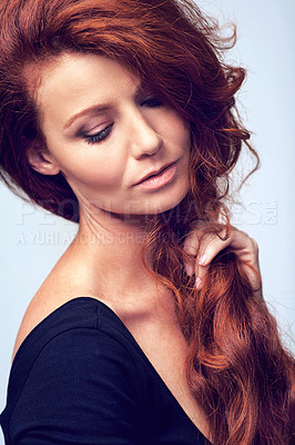 Buy stock photo Beauty, relax and woman in studio with haircare, natural keratin glow and healthy hairstyle. Growth, shine and confident girl with red hair, wellness and luxury salon treatment on blue background