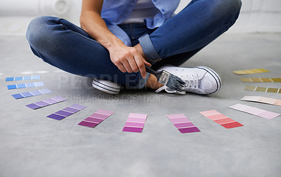 Buy stock photo Shot of a female sitting crossed legged chosing paint colours