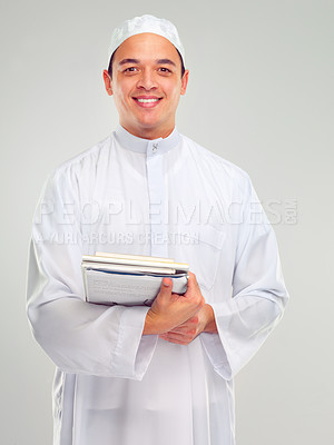 Buy stock photo Islamic man, smile portrait and books for learning standing in white background for Arabic culture. Young person, smile and religion faith, hope or studying for Muslim education isolated in studio