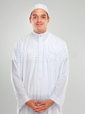 Buy stock photo Portrait, islam and religion with a muslim man in studio on a gray background for faith, belief in god or devotion. Eid, worship and ramadan with a male arab fasting in holy tradition or culture