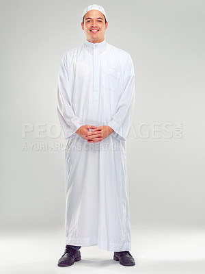 Buy stock photo Islamic man, religion fashion and standing for worship, prayer or spiritual happiness in white background. Arabic person, smile and happy respect for muslim culture or clothes isolated in studio