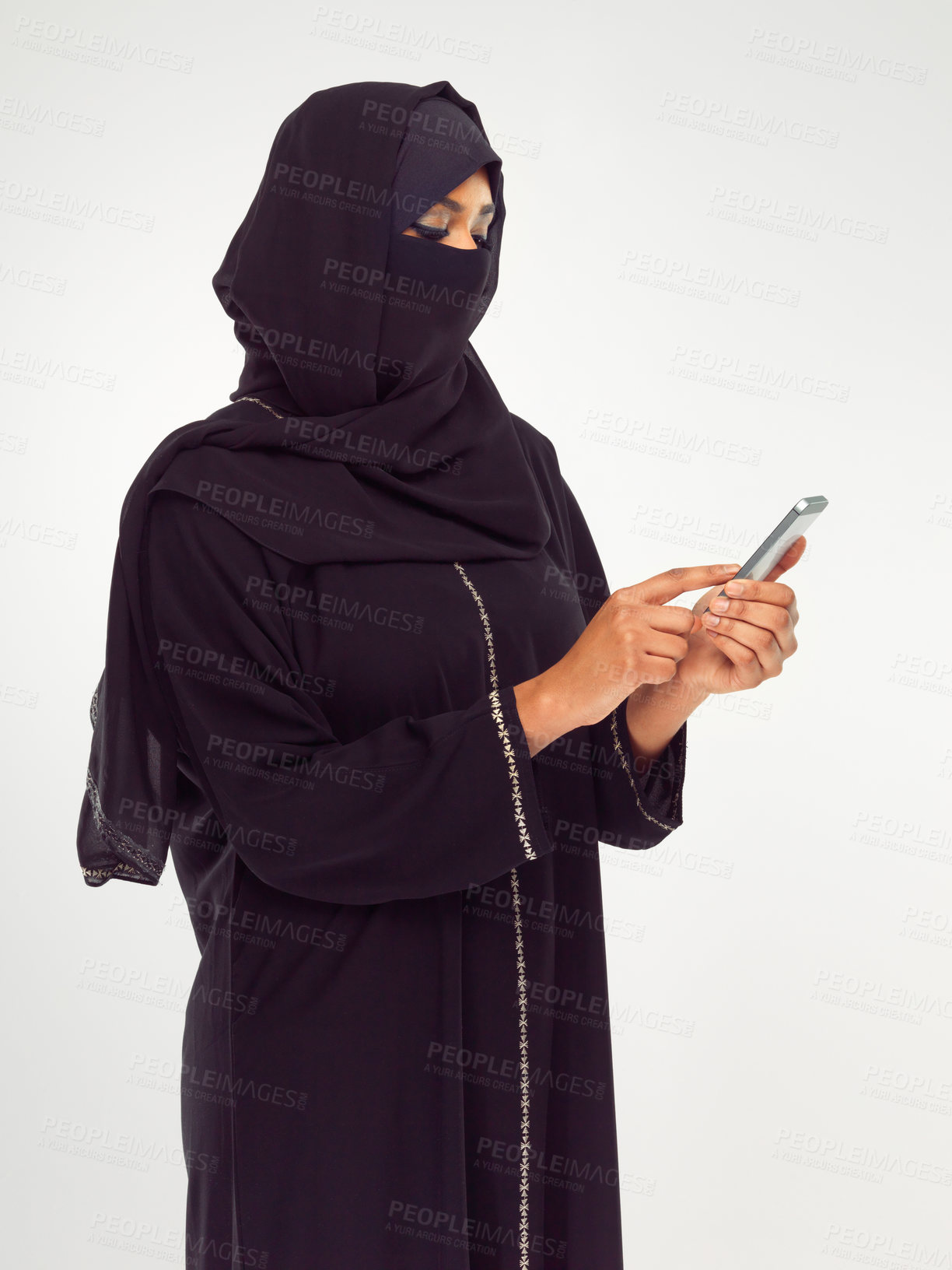 Buy stock photo Muslim, phone and social media with an islamic woman in studio on a gray background for communication or networking. Contact, internet and islam with a female typing a text message or online post