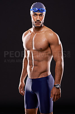 Buy stock photo Studio shot of a handsome swimmer against a black background
