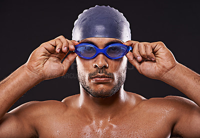 Buy stock photo Studio, swimmer and man with goggles for sport and workout for training and exercise for body. Athlete, adult and male person with strength, professional and champion for career in black background