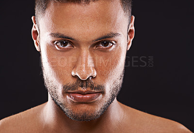 Buy stock photo Studio portrait of a handsome young man against a black background