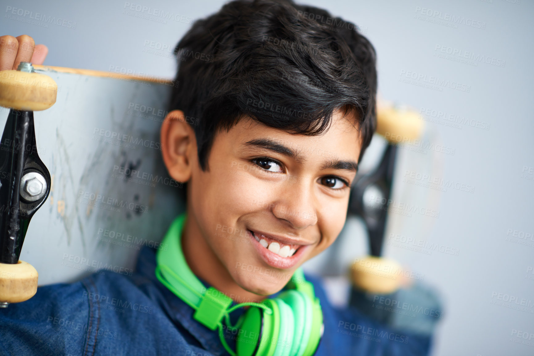 Buy stock photo A portrait of a happy young boy holding his skateboard