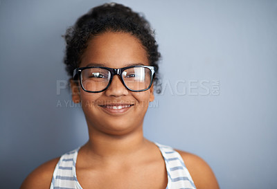 Buy stock photo Happy child, girl and portrait in studio with glasses, education and pride in school or academic excellence. Kid, face and smile in prescription eyewear to support learning, eyecare and ophthalmology