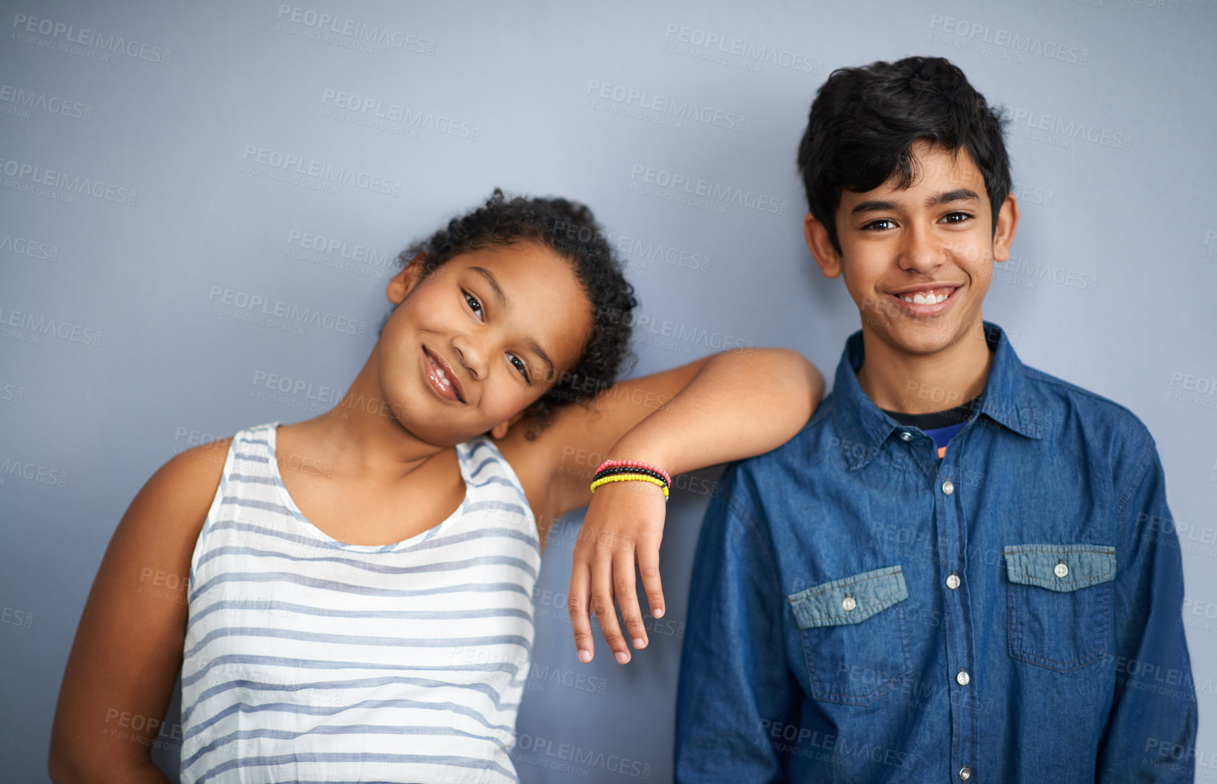 Buy stock photo A cute brother and sister standing isolated on grey