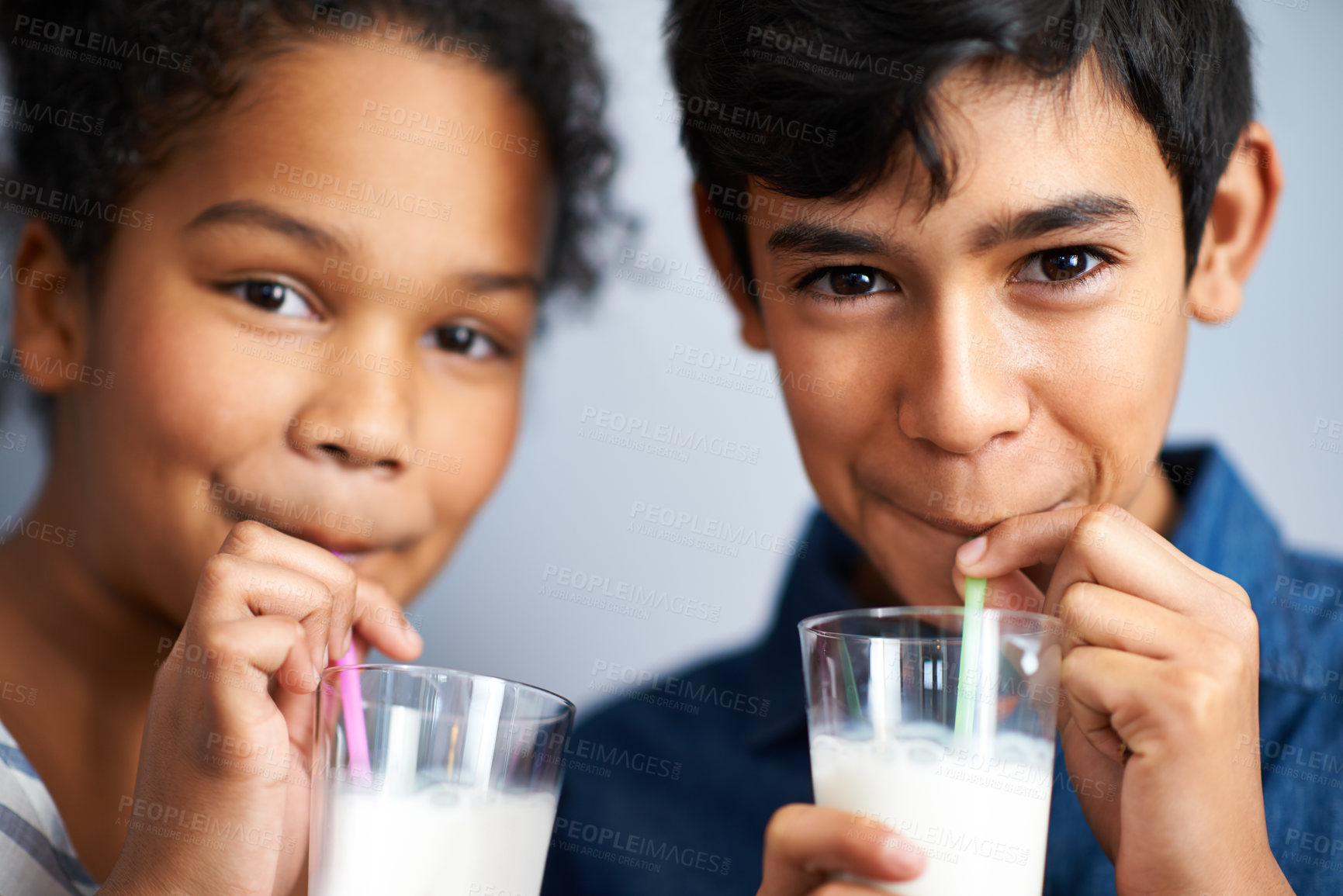 Buy stock photo A brother and sister drinking milk together