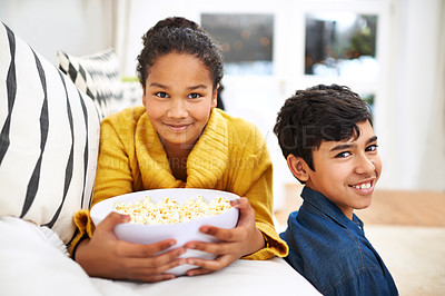 Buy stock photo Happy family, siblings and popcorn in portrait in home and relax or bonding together on weekend. Boy, girl and positive face of teenagers on couch, peace and snack for school holiday in living room