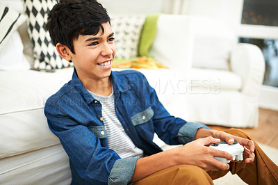 Buy stock photo Living room, play and video games for boy with smile, fun and joy to relax on floor with technology. Lounge, preteen and kid with happiness in apartment, home and gamer with controller or gamepad