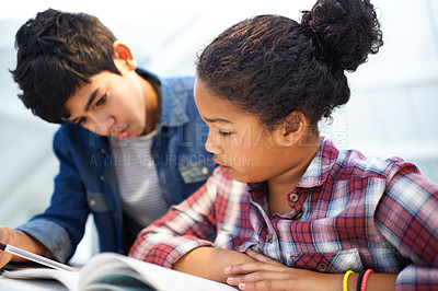 Buy stock photo Shot of a brother and sister studying together