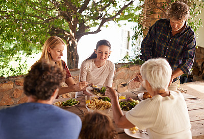 Buy stock photo Food, party and eating with family at lunch in outdoor for happy, bonding and celebration. Vacation, social and event with parents and children share salad together for dining, generations and health