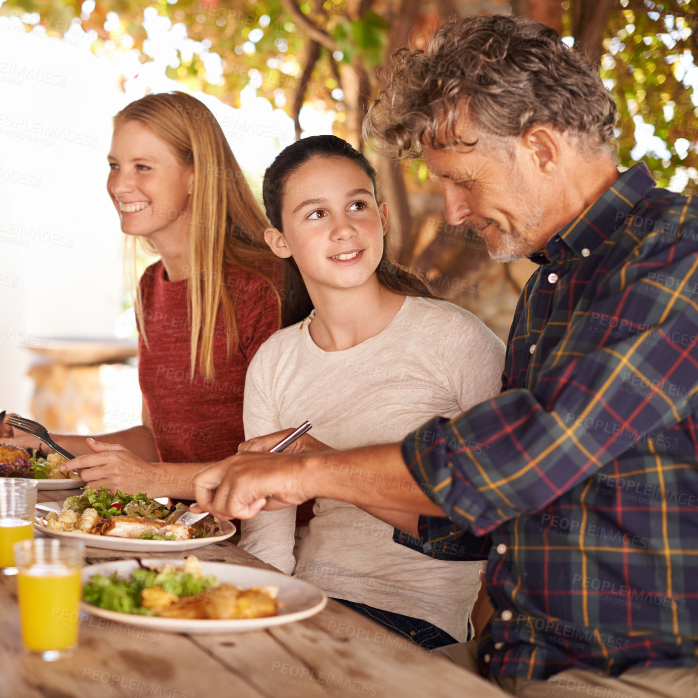 Buy stock photo Family, outdoor and lunch with celebration, happiness and smile with social gathering and bonding together. Parents, group and mother with father and daughter with food and healthy meal with sunshine