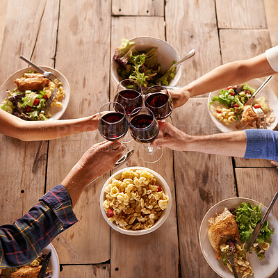 Buy stock photo Hands, toast with wine glasses and food with cheer for celebration at lunch. Top view of event, congratulations or success and friends or family sharing a meal or dish together at table with drinks