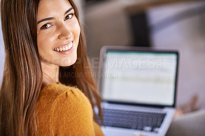 Buy stock photo A young woman on the couch with her laptop